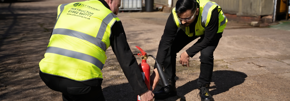 Fire Marshal Training with a fire extinguisher.