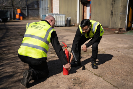 Fire Marshal Training with a fire extinguisher.