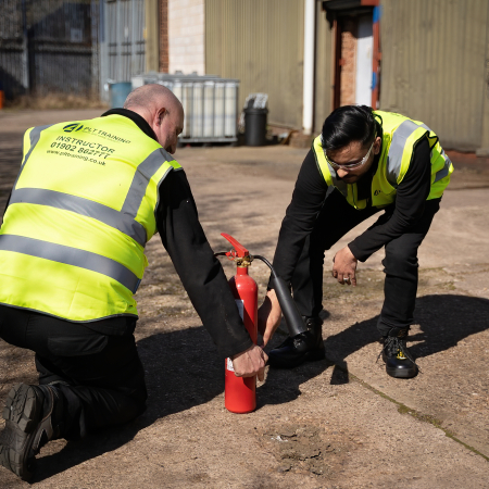 Fire Marshal Training with a fire extinguisher.