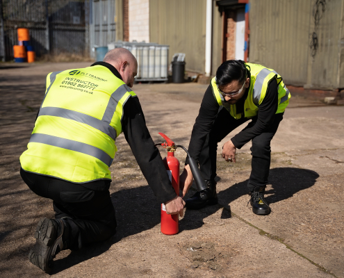 Fire Marshal Training with a fire extinguisher.